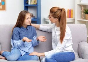 therapist explaining the trauma therapy program to a teenage girl